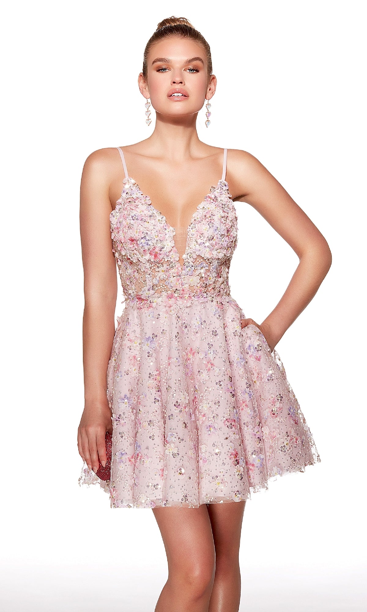 A woman wears the Alyce 30017 short homecoming dress, featuring a sleeveless, floral-patterned, fit-and-flare design with a fitted bodice and flared skirt, standing against a plain white background.