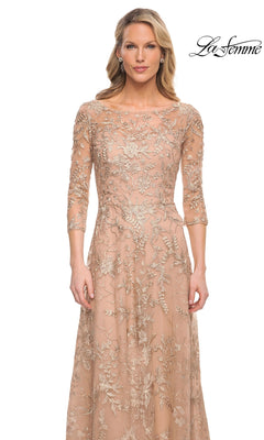 A floor-length Long Formal Dress: La Femme 30021 with three-quarter sleeves and a boat neckline, featuring metallic floral lace embroidery over a nude lining.