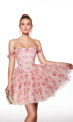 A woman poses against a white background in the Alyce 30021 off-shoulder short print hoco dress, featuring a pink floral corset bodice. She accessorizes with a beaded clutch and large pearl earrings.