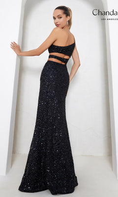A woman poses in the Cut-Out Long Sequin Prom Dress: Chandalier 30022—a black, one-shoulder, two-piece formal dress with a fitted, floor-length skirt—against a plain white background.
