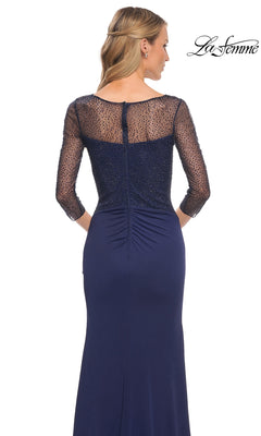 Woman in Long Formal Dress: La Femme 30028, navy jersey with beaded applique sleeves and sheer back. Shown from behind, features zipper closure and slight waist ruching.