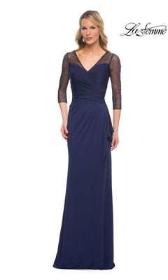 A woman wears the Long Formal Dress: La Femme 30028 in navy with lace three-quarter sleeves, standing forward against a white background. The La Femme logo is at the top right.