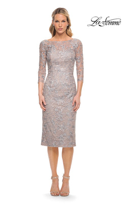 A woman wears a mauve and silver La Femme 30036 midi wedding guest dress, featuring a sheath silhouette, three-quarter sleeves, a boat neckline, and embellished embroidered floral detailing.