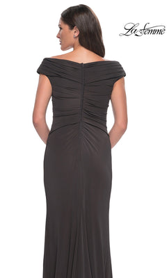 Woman wearing La Femme 30040 long formal dress with off-the-shoulder V-neckline, gathered jersey fabric, cap sleeves, and zip detail. “La Femme” logo in top right corner.