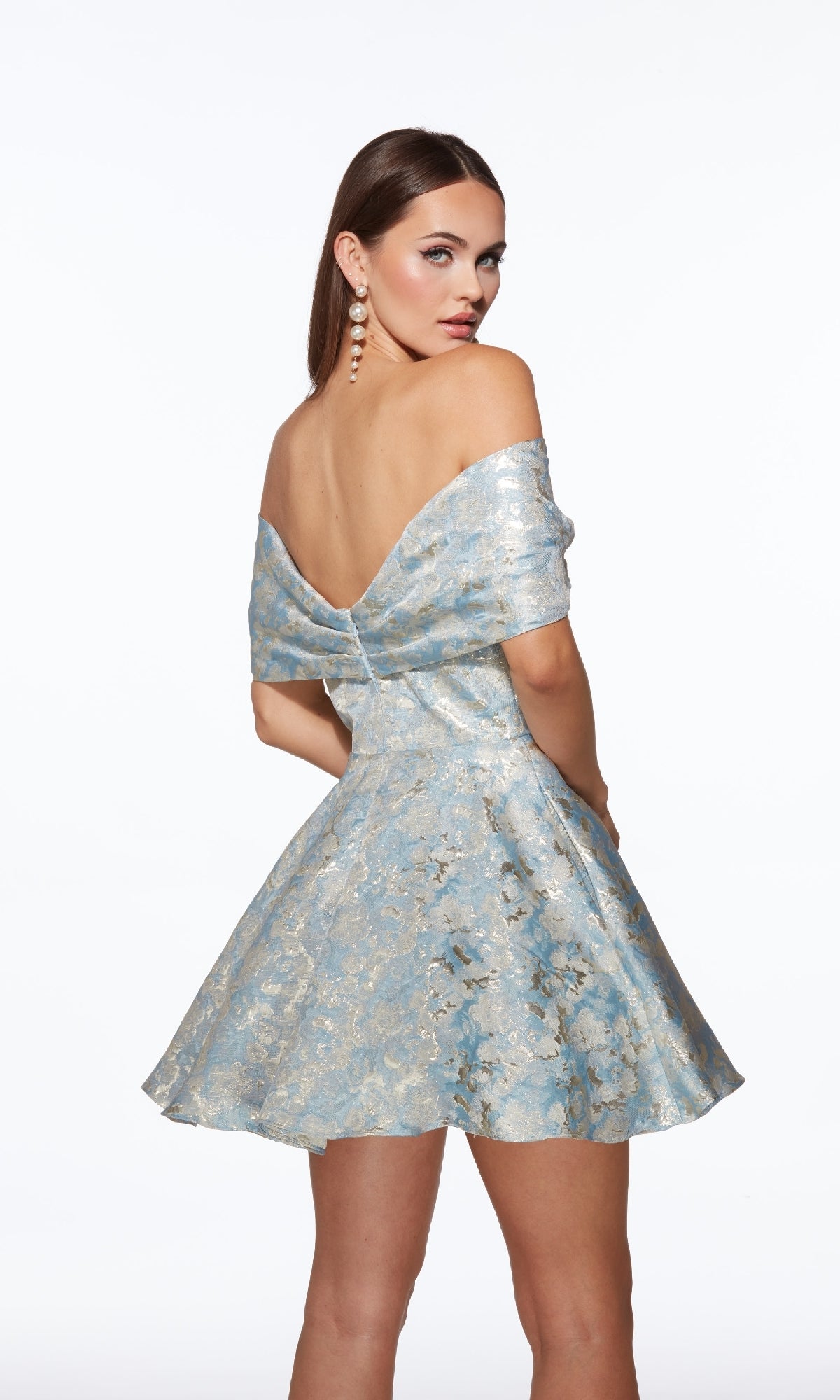 A woman models the Alyce 30046 short homecoming dress—an off-the-shoulder, light blue dress with a flared skirt and floral brocade—against a plain white background.
