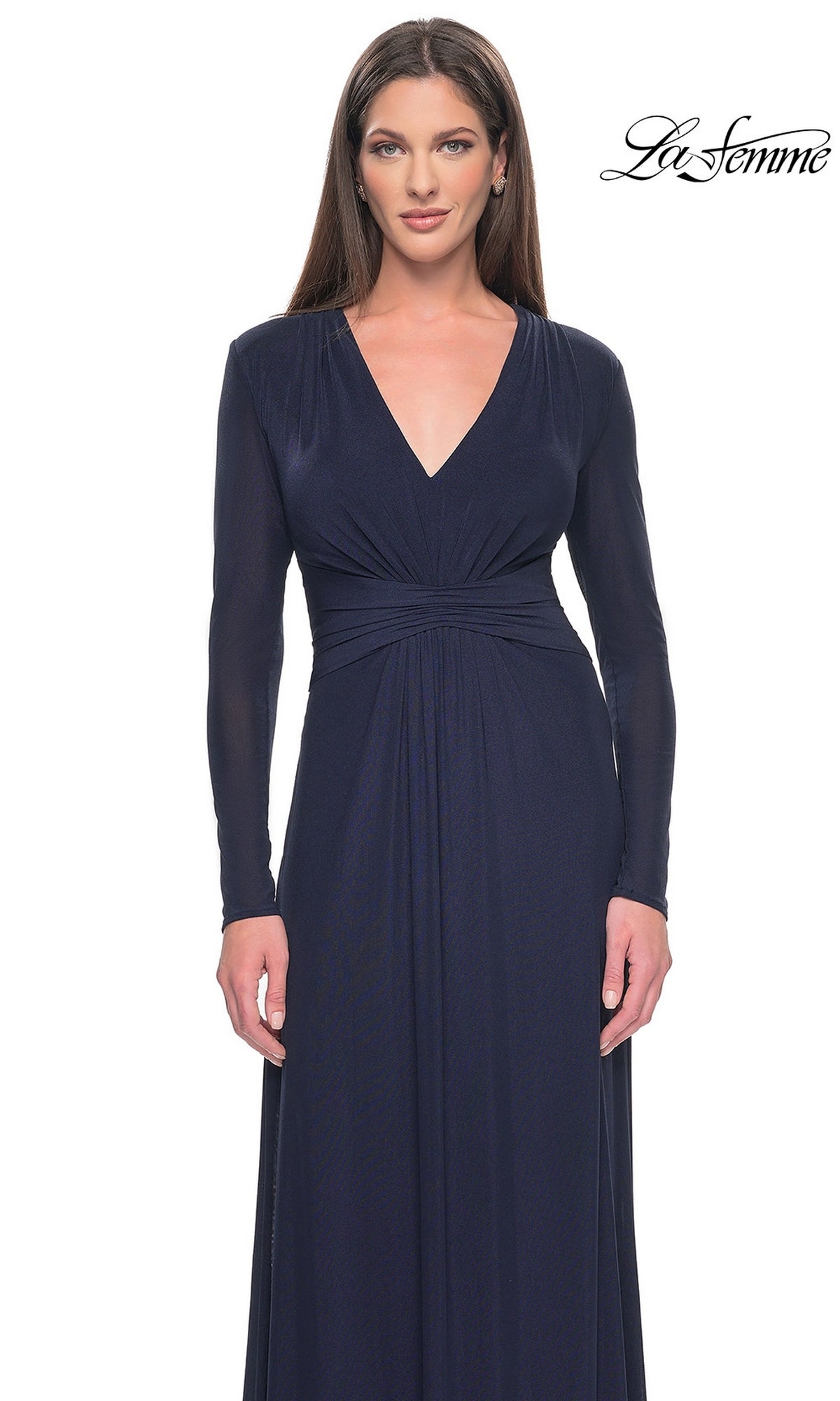 A woman wearing a dark blue, long-sleeved modest formal dress, Long Formal Dress: La Femme 30048, featuring a V-neckline and gathered waist detail.
