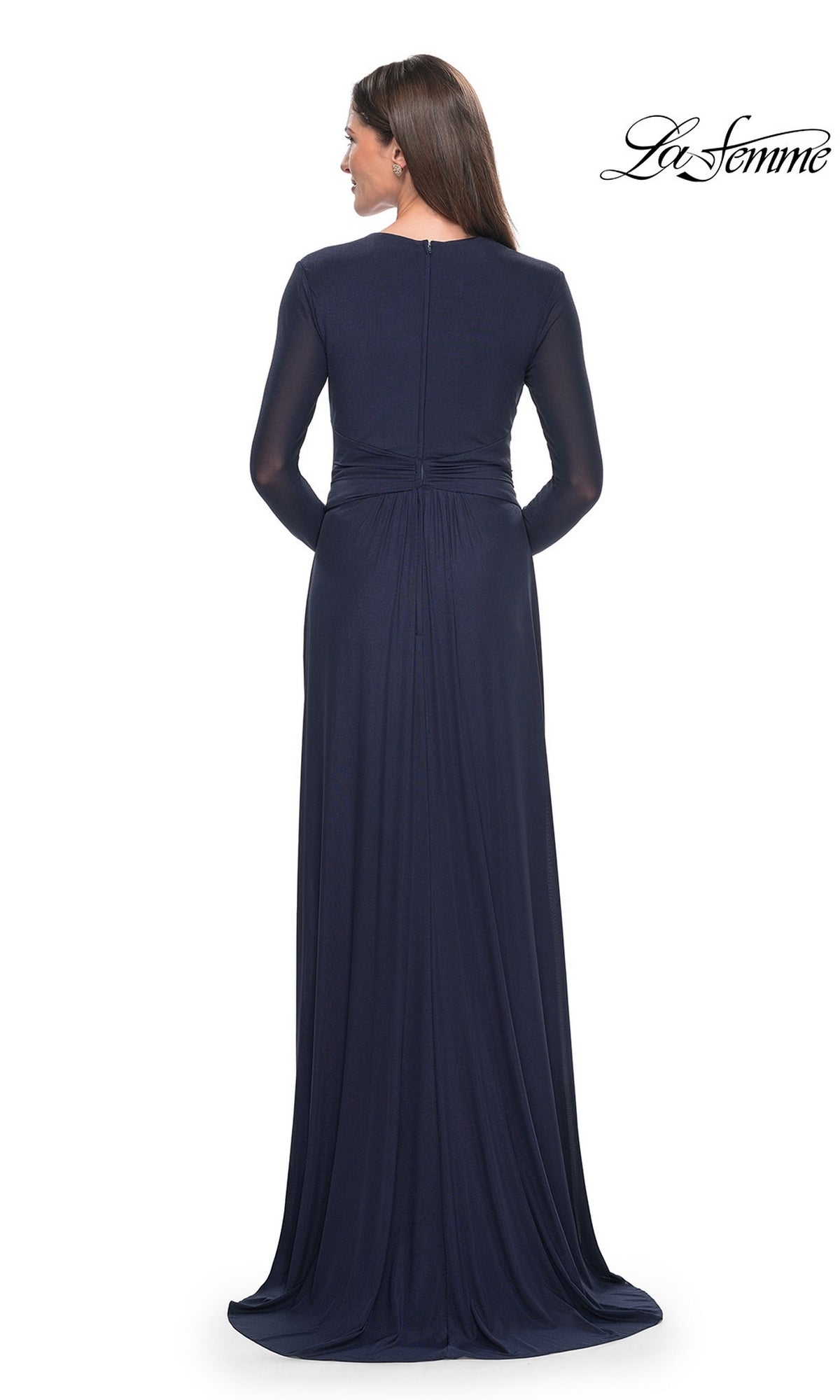 Back view of a woman wearing a La Femme 30048 modest formal long-sleeved navy blue gown with a gathered waist.