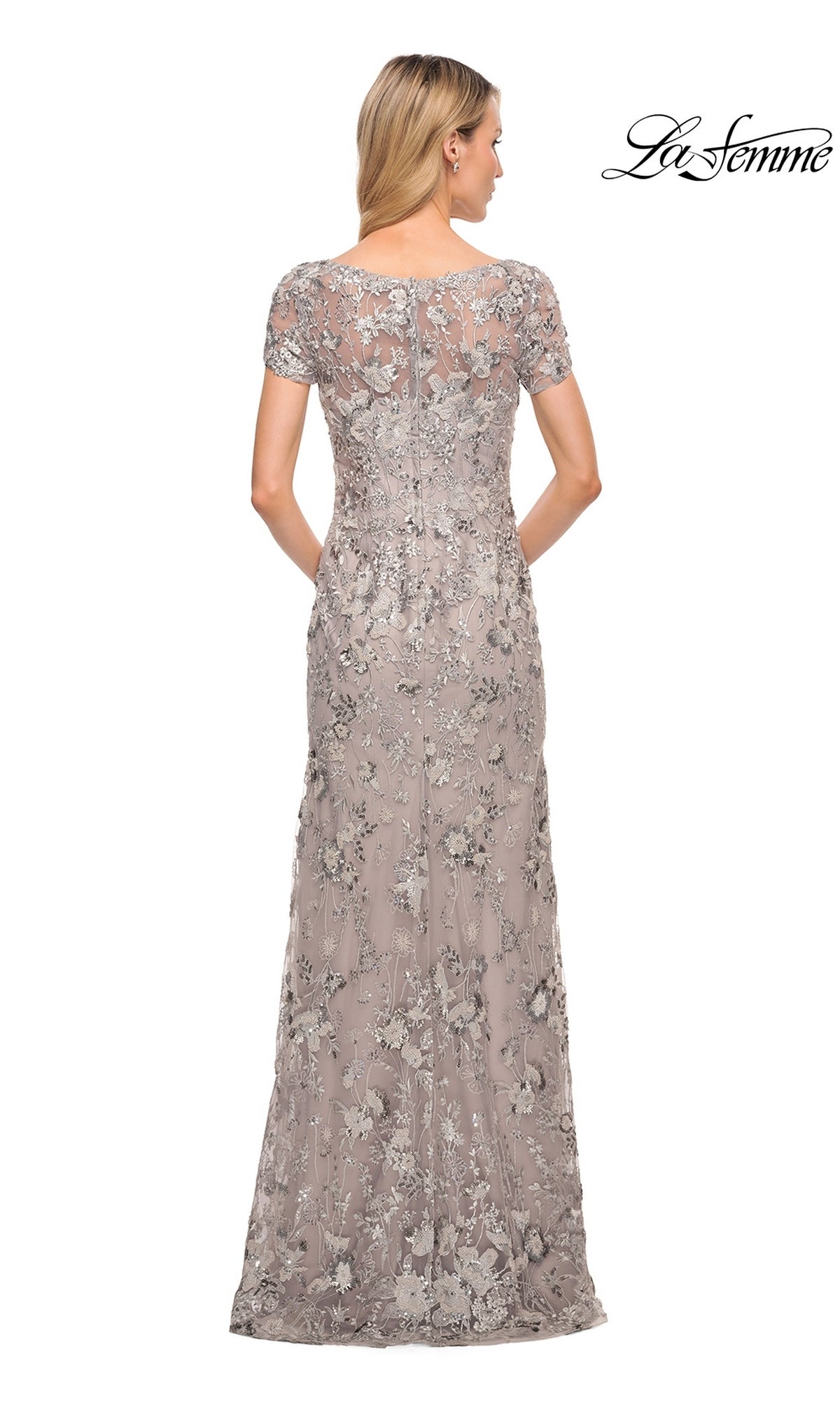 Back view of a woman wearing a La Femme 30053 floor-length taupe silver grey formal dress with short sleeves and silver floral embroidery.
