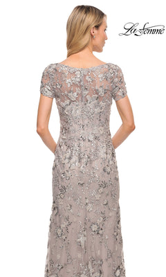 Back view of the Long Formal Dress: La Femme 30053, a floor-length, short-sleeved embroidered sheath evening gown with silver floral embroidery and sequins over a beige base.