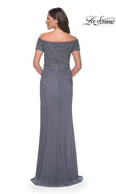 Woman models the Long Formal Dress: La Femme 30057, a floor-length, off-the-shoulder beaded sheath with detailed bodice; La Femme logo shown in upper right.