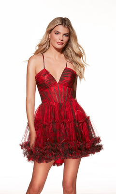 Woman wearing the Lace-Up Short Print A-Line Hoco Dress (Alyce 30057), featuring a red and black tulle design with spaghetti straps and a fitted bodice, standing against a plain white background.
