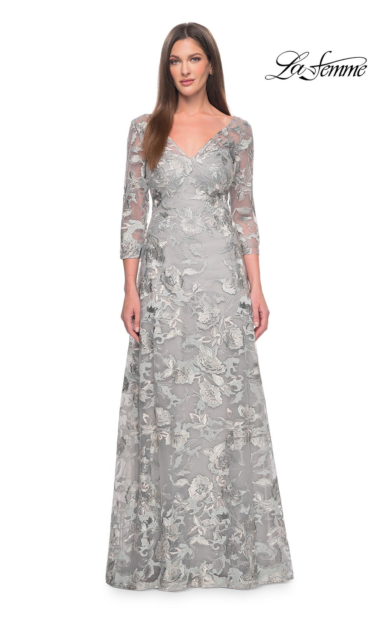 A woman wearing a Long Formal Dress: La Femme 30062 in slate-gray, featuring three-quarter sleeves, a floor-length A-line silhouette, and all-over floral embroidery.