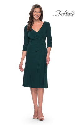 A woman wears a hunter green, midi-length, v-neck jersey Midi Wedding Guest Dress: La Femme 30069 with three-quarter sleeves and a gathered, fit-and-flare waist.