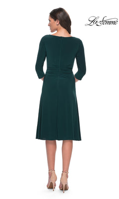 Back view of a woman wearing a dark green Midi Wedding Guest Dress: La Femme 30069 with three-quarter sleeves and beige high heels.