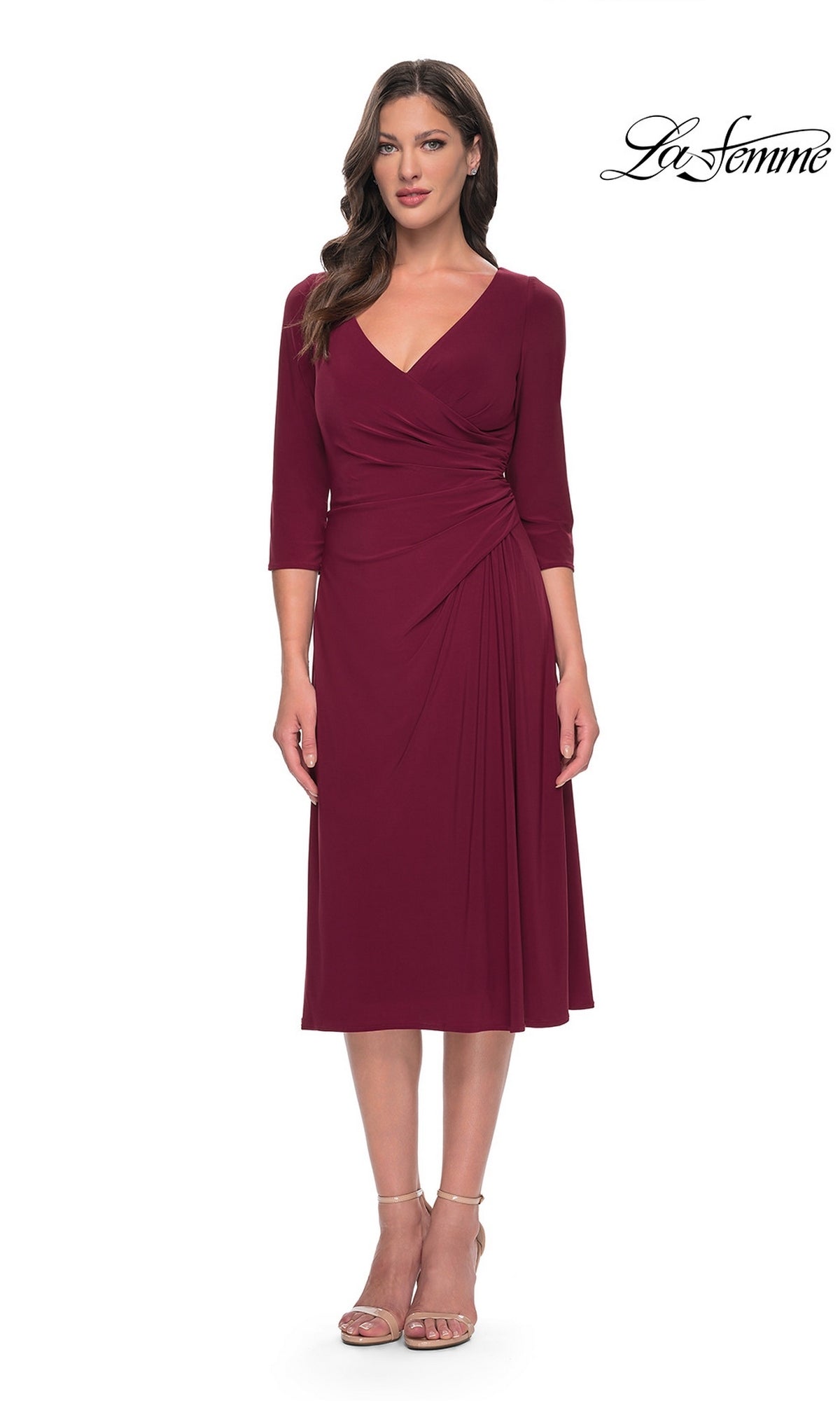 A wine-colored Midi Wedding Guest Dress: La Femme 30069 with three-quarter sleeves, a V-neckline, and draped waist detailing, worn with strappy heels.