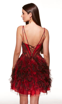 Woman facing away, wearing the Short Print Fit-and-Flare Hoco Dress Alyce 30078 with ruffles, a lace-up back, and thin straps.