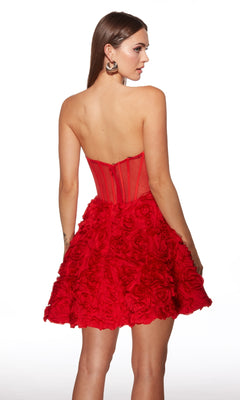 A woman models the Alyce 30079 Short Homecoming Dress, showcasing its strapless fit-and-flare silhouette with a textured floral skirt and sheer corset bodice, posed against a white background.