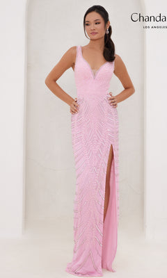 A woman poses with hands on hips against a plain white background, wearing the Chandalier Long Prom Dress 30081—a light pink, sleeveless sequin print formal dress with a v-neckline and thigh-high slit.