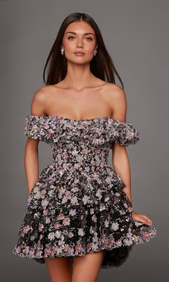 A woman wears the Alyce 30115 Short Homecoming Dress, showcasing an off-shoulder, ruffled mini design in a black/multi floral pattern, while standing against a plain gray background.
