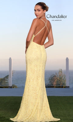 A woman in a yellow Long Prom Dress 30118 by Chandalier stands on grass, facing away, with the ocean and sky behind her. "Chandalier Los Angeles" text appears on the image.