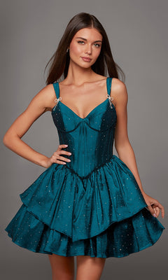 A woman poses with one hand on her hip against a plain grey background, wearing the Short Homecoming Dress: Alyce 30122—a teal, sleeveless, tiered fit-and-flare dress adorned with sparkling rhinestone embellishments.