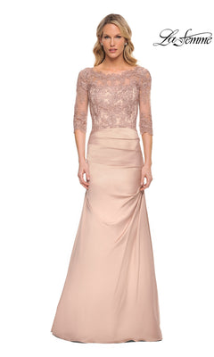 Woman in a Long Formal Dress: La Femme 30162 in champagne with lace three-quarter sleeves and fitted satin skirt, standing against a white background. “La Femme” logo top right.