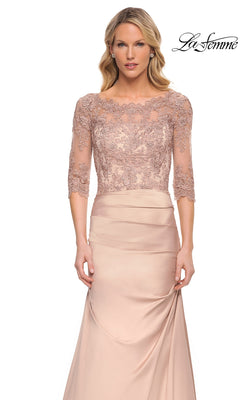 Woman wearing Long Formal Dress: La Femme 30162, a blush pink gown with lace bodice and 3/4 sleeves, standing before a white background with “La Femme” logo.