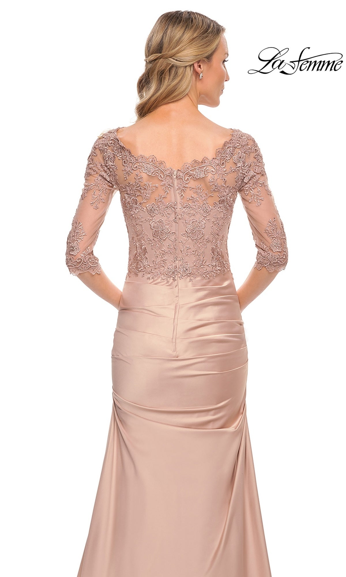 A woman in the Long Formal Dress: La Femme 30162—blush pink, lace bodice with floral embroidery, three-quarter sleeves—shown from the back, ideal for a mother-of-the-bride.