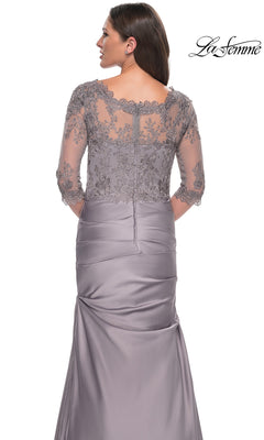A woman models the Long Formal Dress: La Femme 30162, featuring a silver-gray lace bodice and sheer floral-embroidered back and sleeves, shown from behind.