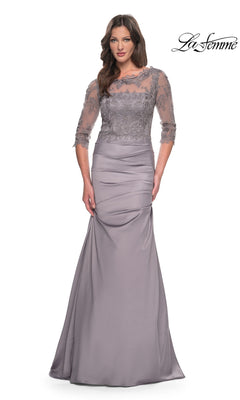 Woman in a silver Long Formal Dress: La Femme 30162 with lace bodice and three-quarter sleeves, perfect for mother-of-the-bride, stands against a white background.