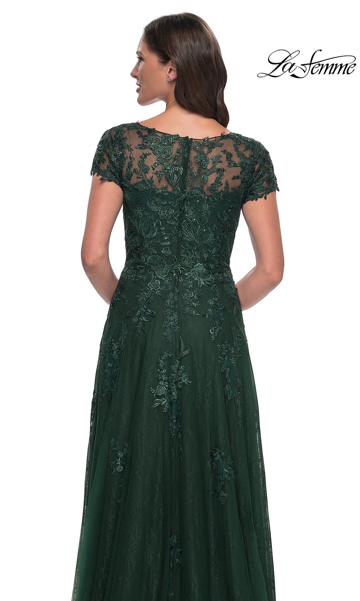 Back view of a woman in a La Femme 30168 long formal dress, a floor-length, dark green lace gown with cap sleeves and a sheer illusion neckline.