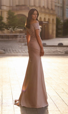 Woman wearing a mauve, floor-length mermaid silhouette La Femme 30199 gown with an off-the-shoulder neckline and lace detailing on the bodice.