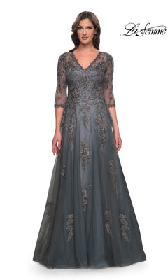 A woman wears a gray, floor-length V-neck Long Formal Dress: La Femme 30201 with three-quarter sleeves and ornate lace appliques.