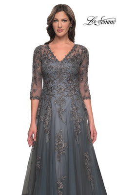A woman wearing a charcoal gray, V-neck La Femme 30201 mother of the bride dress with three-quarter sleeves and floral lace appliques.