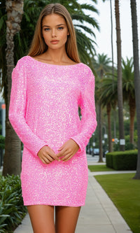 Woman wearing a pink sequin dress standing outdoors with palm trees in the background