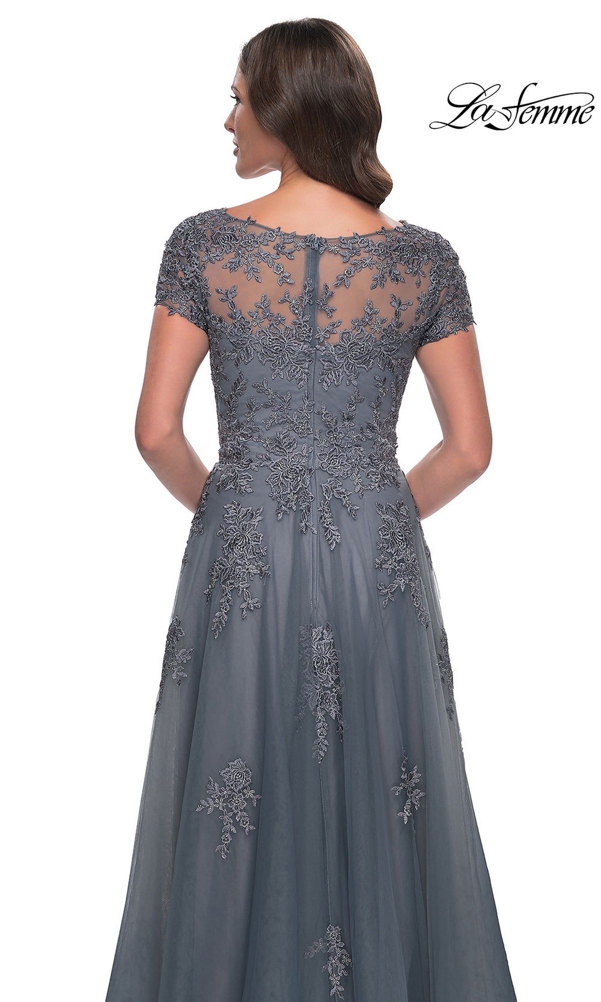 Back view of a woman wearing a grey La Femme 30228 long formal dress featuring short cap sleeves and floral lace embroidery on the bodice.