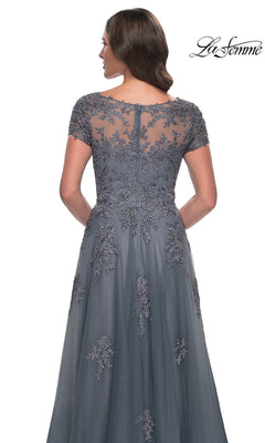Back view of a woman wearing a grey La Femme 30228 long formal dress featuring short cap sleeves and floral lace embroidery on the bodice.