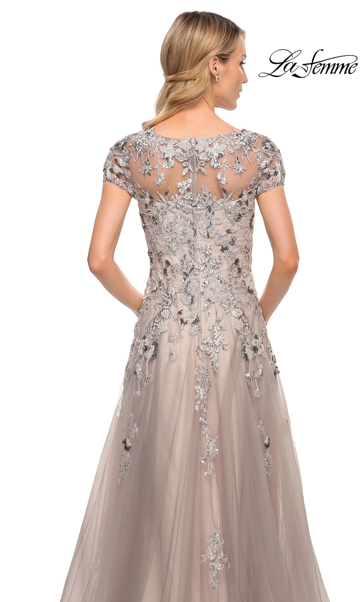 Back view of the Long Formal Dress: La Femme 30239, a floor-length silver dress with cap sleeves, floral embroidery, sequins over a nude-toned bodice, and a tulle A-line skirt.