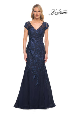 Woman wearing a navy, floor-length, short-sleeved V-neck La Femme 30269 formal dress with a mermaid silhouette and floral lace embroidery.
