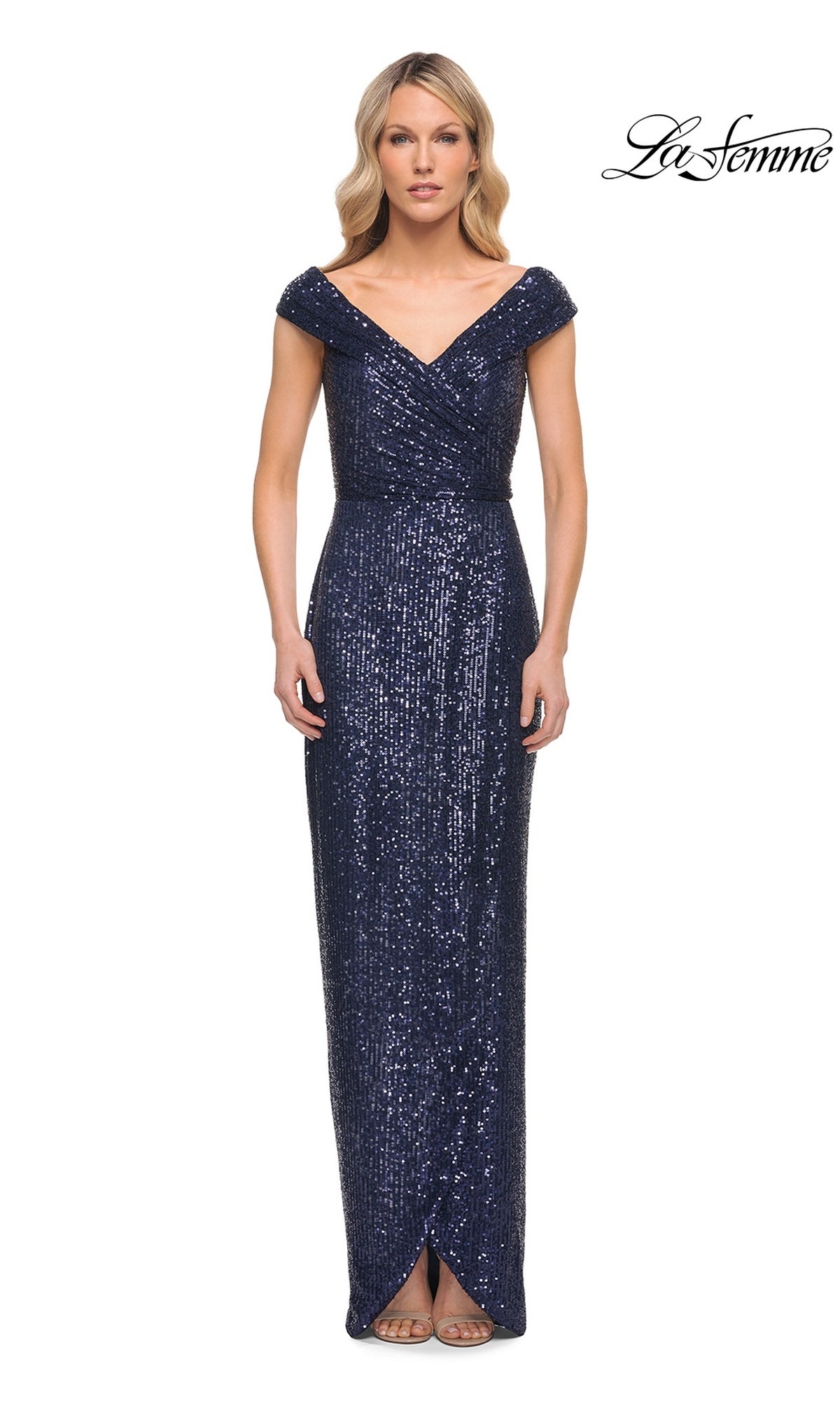 Woman wearing La Femme 30326, a navy floor-length sequin sheath dress with a V-neckline, standing against a white background. “La Femme” logo in top right corner.