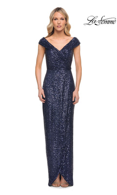 Woman wearing La Femme 30326, a navy floor-length sequin sheath dress with a V-neckline, standing against a white background. “La Femme” logo in top right corner.