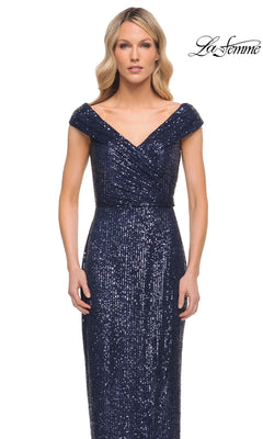Woman models the Long Formal Dress: La Femme 30326—an off-the-shoulder, navy blue sequin sheath—standing against a white background with the La Femme logo.