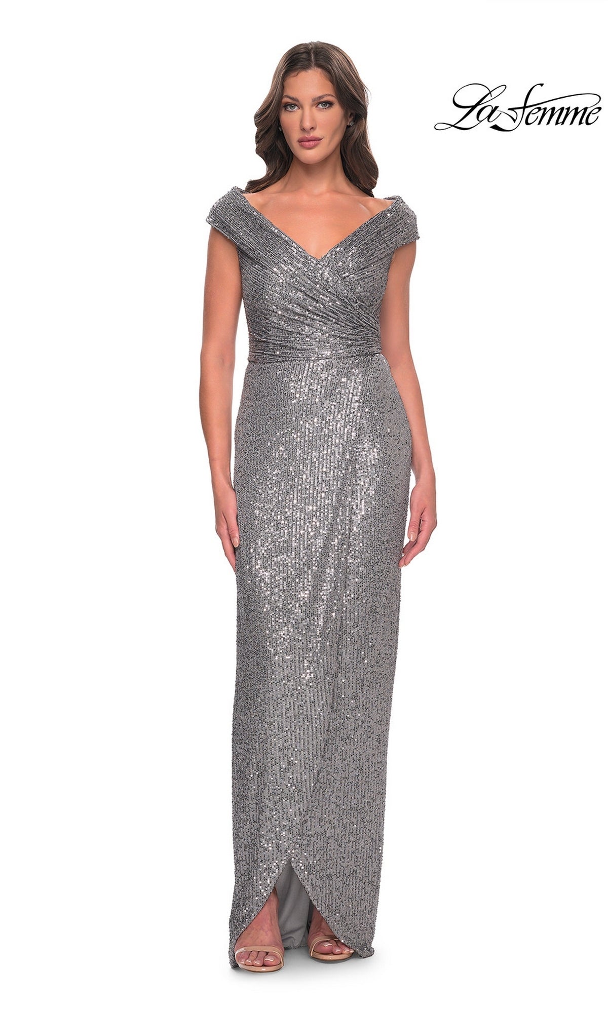 Woman in Long Formal Dress: La Femme 30326, silver sequin sheath with wrap bodice and front slit. “La Femme” logo top right.
