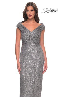 Woman in silver off-the-shoulder long sequin dress with fitted sheath silhouette and draped detail. La Femme 30326 logo appears top right.