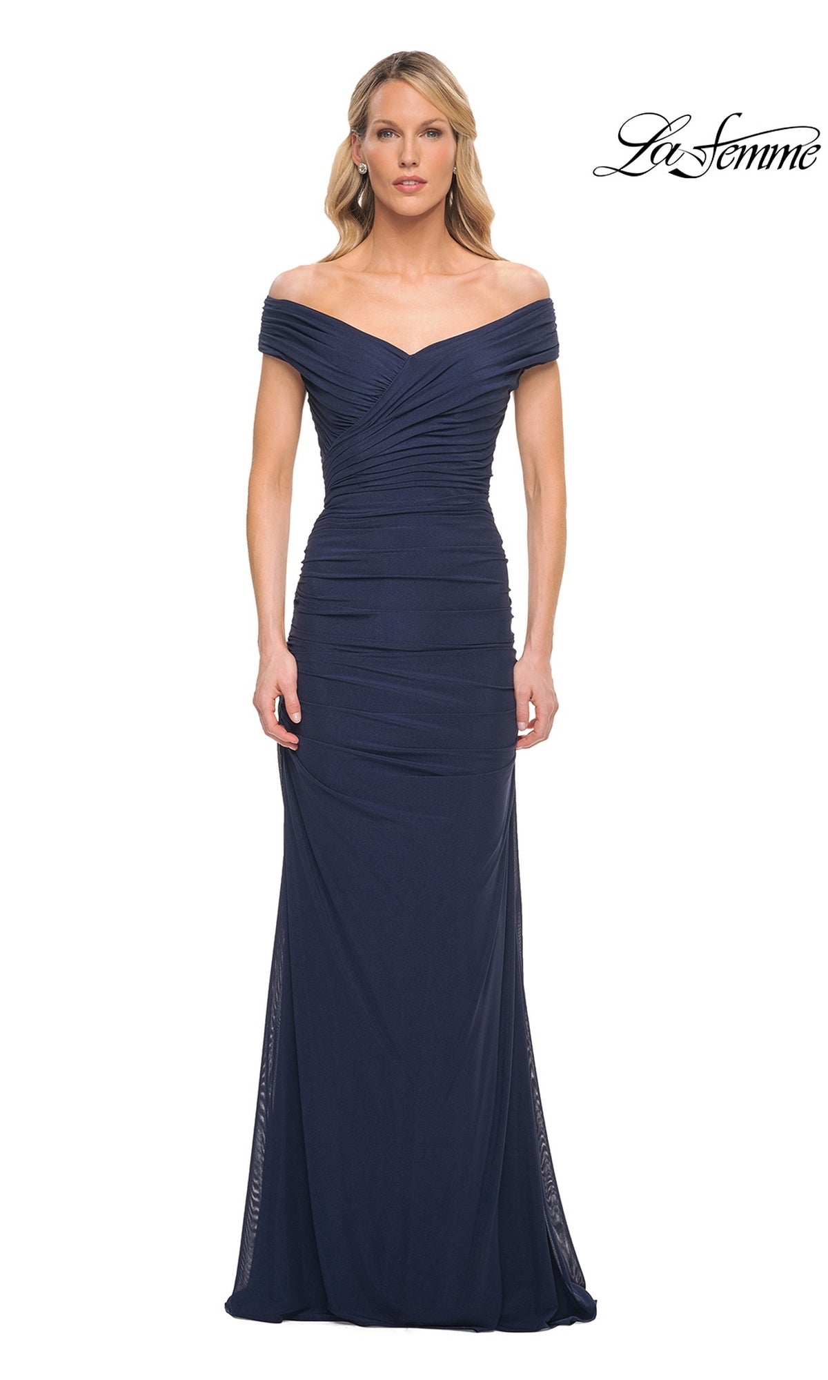 A woman wearing a navy, off-the-shoulder Long Formal Dress: La Femme 30363 with a ruched bodice that falls to the floor.