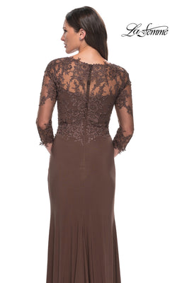 Woman in the Long Formal Dress: La Femme 30384, featuring brown sheer lace sleeves and back, stands facing away. The La Femme logo appears at the top right.