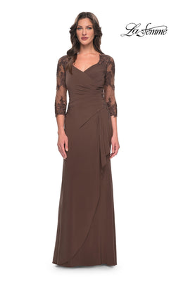 Woman in a cocoa Long Formal Dress: La Femme 30384 with sheer lace sleeves and wrap bodice, perfect for mother-of-the-bride, stands against a white background.