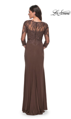 Woman wearing the Long Formal Dress: La Femme 30384, a floor-length brown gown with sheer lace long sleeves and upper back, standing with her back to the camera.