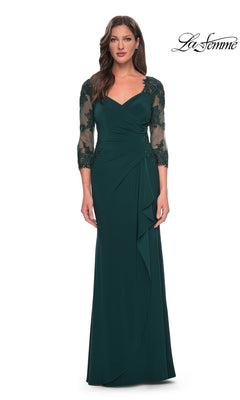 Woman wearing the Long Formal Dress: La Femme 30384 in Hunter Green, featuring sheer lace 3/4 sleeves, V-neckline, and ruched details, stands against a white background.