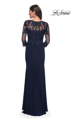 A woman faces away wearing the Long Formal Dress: La Femme 30384 in navy blue, featuring sheer lace sleeves and an embroidered lace back. The La Femme logo is in the top right corner.
